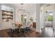 Open dining area with modern chandelier, built-in shelving and a view to the main bedroom at 9454 Becker Ct, Orlando, FL 32827