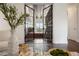 Grand entryway with double glass doors, library, and hardwood floors at 9454 Becker Ct, Orlando, FL 32827