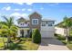 Stunning two-story home with beautifully landscaped front yard and a two-car garage at 9454 Becker Ct, Orlando, FL 32827