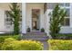 Inviting front entrance with stone steps, manicured shrubs, and a classic blue front door and craftsman details at 9454 Becker Ct, Orlando, FL 32827