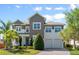 Charming two-story home with a manicured front yard, lush landscaping, and a three-car garage at 9454 Becker Ct, Orlando, FL 32827