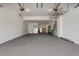 Spacious garage with epoxy floors and ample storage, including hanging storage system and access to additional storage space at 9454 Becker Ct, Orlando, FL 32827