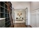 Inviting home office showcasing shelving, ladder, and seamless transition to the bright living room at 9454 Becker Ct, Orlando, FL 32827
