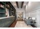 Inviting home office featuring built-in shelving, ladder, seating area, and seamless transition to other living spaces at 9454 Becker Ct, Orlando, FL 32827