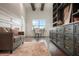 Bright home office featuring built-in shelving, wood beams, desk, and a comfortable seating area at 9454 Becker Ct, Orlando, FL 32827