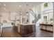 Bright, open-concept kitchen and staircase with hardwood floors and designer fixtures at 9454 Becker Ct, Orlando, FL 32827