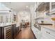 Open concept kitchen features stainless appliances, white cabinets and eat-in dining area at 9454 Becker Ct, Orlando, FL 32827