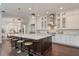Spacious kitchen featuring a large island, white cabinetry, and pendant lighting at 9454 Becker Ct, Orlando, FL 32827