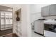 Convenient laundry room with modern washer and dryer units and ample storage shelves at 9454 Becker Ct, Orlando, FL 32827
