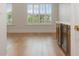 Bright room with hardwood floors and custom cabinets with a beverage fridge at 9454 Becker Ct, Orlando, FL 32827