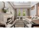Bright living room with fireplace, high ceilings, and French doors leading to outdoor pool at 9454 Becker Ct, Orlando, FL 32827