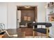 Open living room featuring dark brown walls, hardwood floors, and a wet bar at 9454 Becker Ct, Orlando, FL 32827