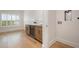 Room with hardwood floors and custom cabinets with a beverage fridge at 9454 Becker Ct, Orlando, FL 32827