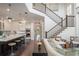 Open-concept living room showing kitchen and stair case, bathed in natural light at 9454 Becker Ct, Orlando, FL 32827
