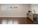 Stylish living room boasts rich hardwood floors, a modern bar area, and ample natural light from shuttered windows at 9454 Becker Ct, Orlando, FL 32827