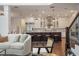 Open-concept living space with kitchen island, modern furnishings, and staircase, perfect for entertaining at 9454 Becker Ct, Orlando, FL 32827