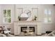 Bright living area with fireplace, stylish decor, and natural light from shuttered windows at 9454 Becker Ct, Orlando, FL 32827