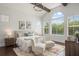 Airy main bedroom with large windows and vaulted ceiling, adorned with modern furnishings at 9454 Becker Ct, Orlando, FL 32827