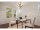 Elegant office with modern chairs, a wooden desk, and ample natural light from large windows at 9454 Becker Ct, Orlando, FL 32827