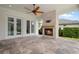 Inviting outdoor living space featuring a stone fireplace and tiled flooring, perfect for entertaining at 9454 Becker Ct, Orlando, FL 32827
