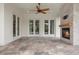 Expansive covered patio with a stone fireplace, recessed lighting, and travertine flooring for relaxation at 9454 Becker Ct, Orlando, FL 32827