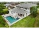 Stunning aerial view of backyard pool with lush landscaping and modern lounge chairs, perfect for relaxation at 9454 Becker Ct, Orlando, FL 32827