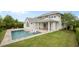 Rear exterior showcasing the backyard swimming pool and covered patio at 9454 Becker Ct, Orlando, FL 32827