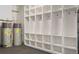 Custom-built storage system featuring shelving and hooks alongside hot water tanks at 9454 Becker Ct, Orlando, FL 32827