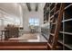 Bright study with hardwood floors and a built-in grey bookcase is ideal for a home office at 9454 Becker Ct, Orlando, FL 32827