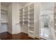 Walk-in closet with custom shelving and hardwood floors at 9454 Becker Ct, Orlando, FL 32827