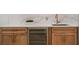 Close-up of the wet bar with marble countertops, cabinetry, and a mini-fridge perfect for entertaining guests at 9454 Becker Ct, Orlando, FL 32827