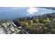Scenic aerial view of a lakeside community with lush greenery and shimmering water views at 10320 Bumblebee Ln, Leesburg, FL 34788