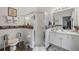 Bathroom featuring a glass-enclosed shower, white vanity, and barn-themed decor at 10320 Bumblebee Ln, Leesburg, FL 34788