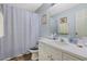 Calm bathroom featuring a shower with a blue curtain and light blue walls at 10320 Bumblebee Ln, Leesburg, FL 34788