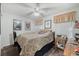Cozy bedroom with neutral tones, ceiling fan, and a comfortable bed at 10320 Bumblebee Ln, Leesburg, FL 34788