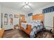Inviting bedroom featuring a wooden bed frame, wood flooring, and natural light at 10320 Bumblebee Ln, Leesburg, FL 34788