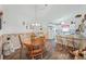 Cozy dining area featuring wood floors, a round wooden table, and decorative accents at 10320 Bumblebee Ln, Leesburg, FL 34788