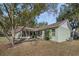 View of backyard featuring mature trees and screened-in porch at 10320 Bumblebee Ln, Leesburg, FL 34788