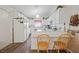 Bright kitchen with white cabinets, a breakfast bar, and wood-look flooring at 10320 Bumblebee Ln, Leesburg, FL 34788