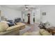 Inviting living room with ceiling fan, wood-look floors, and cozy seating, perfect for relaxation and entertainment at 10320 Bumblebee Ln, Leesburg, FL 34788