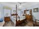 Charming main bedroom with a four-poster bed and ample natural light at 10320 Bumblebee Ln, Leesburg, FL 34788