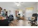Bright office space with wood-look floors, two work stations, and ample natural light at 10320 Bumblebee Ln, Leesburg, FL 34788