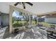 Covered porch with golf course views, seating area, and peaceful setting at 10320 Bumblebee Ln, Leesburg, FL 34788