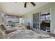 Relaxing screened-in porch with comfortable seating and a ceiling fan at 10320 Bumblebee Ln, Leesburg, FL 34788