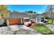 Street view of single-story home, featuring a driveway and well maintained lawn and landscape at 109 Oakridge Ct, Sanford, FL 32773