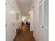 Inviting hallway with wood flooring, a closet, and an open view into the living and dining areas at 109 Oakridge Ct, Sanford, FL 32773