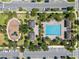 A vibrant community park with a playground and pool surrounded by landscaping, located on a well maintained neighborhood street at 13315 Sproston Pt, Orlando, FL 32832