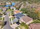 An aerial view captures the community's well-maintained homes, streets and landscaping around a serene pond at 13315 Sproston Pt, Orlando, FL 32832