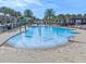 Outdoor community kid-friendly pool with palm trees, splash toys, and a shaded area, perfect for Gathering fun and relaxation at 13315 Sproston Pt, Orlando, FL 32832