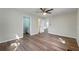 Bedroom featuring a ceiling fan, wood floor, and ensuite bathroom at 1343 Spring Lake Rd, Fruitland Park, FL 34731